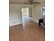 Open living area with tiled floors, a ceiling fan, and an arched doorway leading to other rooms at 4611 W Mcelroy Ave, Tampa, FL 33611