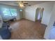 Inviting living room with tiled flooring, a ceiling fan, and a front door leading to the exterior at 4611 W Mcelroy Ave, Tampa, FL 33611