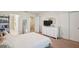 Bedroom featuring a comfortable bed, dresser, and closet, for ample storage at 4935 White Sanderling Ct, Tampa, FL 33619