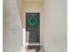 Inviting front door adorned with a festive wreath and a decorative welcome mat at 4935 White Sanderling Ct, Tampa, FL 33619