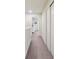 Upstairs hallway with carpet flooring and white trim, and convenient closet space at 4935 White Sanderling Ct, Tampa, FL 33619
