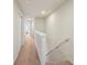 Bright hallway with neutral paint and carpet flooring, leading to bedrooms at 4935 White Sanderling Ct, Tampa, FL 33619