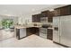 A modern kitchen features stainless steel appliances and granite countertops at 4935 White Sanderling Ct, Tampa, FL 33619