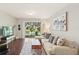 Bright living room with a comfortable couch, wood floors and sliding glass doors to the outside at 4935 White Sanderling Ct, Tampa, FL 33619