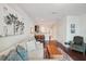 Open concept living room with a neutral couch, dark wood floors and white walls throughout at 4935 White Sanderling Ct, Tampa, FL 33619