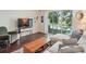 A bright living room with views of the outdoors and a comfortable couch near a TV at 4935 White Sanderling Ct, Tampa, FL 33619