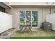 Patio with table and chairs overlooking a serene lake, offering a relaxing outdoor space at 4935 White Sanderling Ct, Tampa, FL 33619