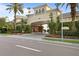 Arbor Place City Homes entrance showcasing tropical landscaping and an elegant covered entry at 501 Knights Run Ave # 2218, Tampa, FL 33602