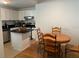 Eat-in kitchen features white cabinetry, black countertops, and stainless-steel appliances at 501 Knights Run Ave # 2218, Tampa, FL 33602