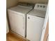 Bright laundry area featuring a Whirlpool washing machine and a modern dryer for convenient clothes care at 501 Knights Run Ave # 2218, Tampa, FL 33602