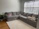 Cozy living room featuring plush seating, a large window, and hardwood floors at 501 Knights Run Ave # 2218, Tampa, FL 33602