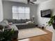 Bright living room with hardwood floors, plush sectional, and a view of the window at 501 Knights Run Ave # 2218, Tampa, FL 33602