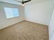 Bedroom with neutral carpet, a ceiling fan, and a window with blinds providing a comfortable space at 5154 Balsam Dr, Land O Lakes, FL 34639