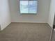Simple bedroom showcasing neutral carpet and a window with blinds for a minimalist aesthetic at 5154 Balsam Dr, Land O Lakes, FL 34639