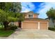 Charming two-story home with a three car garage and lush landscaping at 5154 Balsam Dr, Land O Lakes, FL 34639