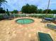 Community hot tub surrounded by lounge chairs and tables, enclosed by a white fence at 5154 Balsam Dr, Land O Lakes, FL 34639