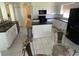 Bright kitchen featuring modern white cabinetry, black countertops and stainless-steel appliances at 5154 Balsam Dr, Land O Lakes, FL 34639