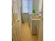 Functional laundry room with a washer, dryer, and ironing board near a window, offering convenience at 5154 Balsam Dr, Land O Lakes, FL 34639