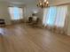 Bright living room with hardwood floors, neutral walls, and chandelier at 5154 Balsam Dr, Land O Lakes, FL 34639