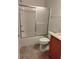 This is a bathroom featuring a tub with glass sliding doors and vanity with granite top at 5473 Sunset Falls Dr, Apollo Beach, FL 33572