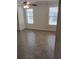 Bright bedroom featuring tile floors, a ceiling fan, and two windows with blinds for natural light at 5473 Sunset Falls Dr, Apollo Beach, FL 33572