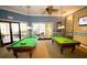 Fun game room featuring two pool tables, comfortable seating, and a lively atmosphere for entertainment at 5473 Sunset Falls Dr, Apollo Beach, FL 33572