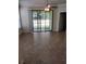 Bright living room featuring tile floors, a ceiling fan, and a large sliding glass door to the patio at 5473 Sunset Falls Dr, Apollo Beach, FL 33572