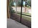 View from a screened patio, showcasing the outdoor space and garden area with privacy fence at 5473 Sunset Falls Dr, Apollo Beach, FL 33572
