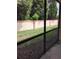 View of a screened patio area overlooking a well-maintained yard and privacy fence at 5473 Sunset Falls Dr, Apollo Beach, FL 33572