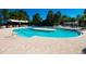 A large outdoor swimming pool featuring clear turquoise water and lounge chairs for community enjoyment at 5473 Sunset Falls Dr, Apollo Beach, FL 33572