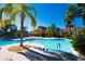 Community pool area with a large pool and lounge chairs, perfect for relaxation and recreation at 5473 Sunset Falls Dr, Apollo Beach, FL 33572