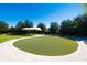 Beautiful community putting green with manicured landscaping and covered seating area at 5473 Sunset Falls Dr, Apollo Beach, FL 33572