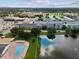 Aerial view of community featuring a large pool, lake with fountain, and several multi-story buildings at 6015 19Th N St # 117, St Petersburg, FL 33714