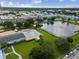 Aerial shot showcasing pool, pond, and serene community, surrounded by lush greenery, under a beautiful sky at 6015 19Th N St # 117, St Petersburg, FL 33714