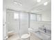 Bright bathroom features a sliding glass shower door, sink, and framed mirror at 6015 19Th N St # 117, St Petersburg, FL 33714