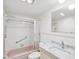Bathroom featuring a shower and bathtub combo with vanity and a framed mirror at 6015 19Th N St # 117, St Petersburg, FL 33714