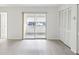Bright bedroom featuring light-colored flooring, closet storage, and sliders to enclosed porch at 6015 19Th N St # 117, St Petersburg, FL 33714