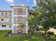 Exterior view of building showcasing unique architectural details and a lush landscaped lawn with decorative plants at 6015 19Th N St # 117, St Petersburg, FL 33714
