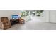 Inviting living room with large windows offering views, plush seating and new flooring at 6015 19Th N St # 117, St Petersburg, FL 33714