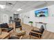 Comfortable waiting area with stylish black leather chairs, wood accents, and a large screen TV at 6015 19Th N St # 117, St Petersburg, FL 33714