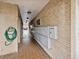 Hallway featuring mailboxes with brick walls and tiled floors, providing a secure location for residents to receive their mail at 6015 19Th N St # 117, St Petersburg, FL 33714