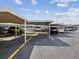 Image features covered parking spaces with visible space numbers and yellow parking lines at 6015 19Th N St # 117, St Petersburg, FL 33714