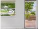 View of a lush exterior with a flowering tree, and a view of passing cars and greenery beyond a window at 6015 19Th N St # 117, St Petersburg, FL 33714