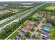 An aerial view of homes located near a lake and a major highway featuring a school and sport fields at 6218 Magnolia Park Blvd, Riverview, FL 33578