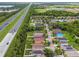 An aerial shot showing homes near highway, lake, sports complex, trees, and neighborhood layout at 6218 Magnolia Park Blvd, Riverview, FL 33578