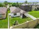 Aerial view of a fenced backyard with a covered patio and well-maintained lawn, offering privacy at 6218 Magnolia Park Blvd, Riverview, FL 33578