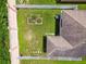 Aerial view of fenced backyard, green lawn, and garden, with a well-maintained roof at 6218 Magnolia Park Blvd, Riverview, FL 33578