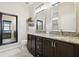 Bathroom featuring granite countertops, and dual sinks, and framed mirrors at 6218 Magnolia Park Blvd, Riverview, FL 33578