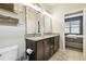 Bathroom featuring granite countertops, and dual sinks, and framed mirrors at 6218 Magnolia Park Blvd, Riverview, FL 33578
