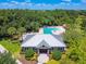 Lovely aerial of a clubhouse with community pool and mature landscaping around perimeter at 6218 Magnolia Park Blvd, Riverview, FL 33578